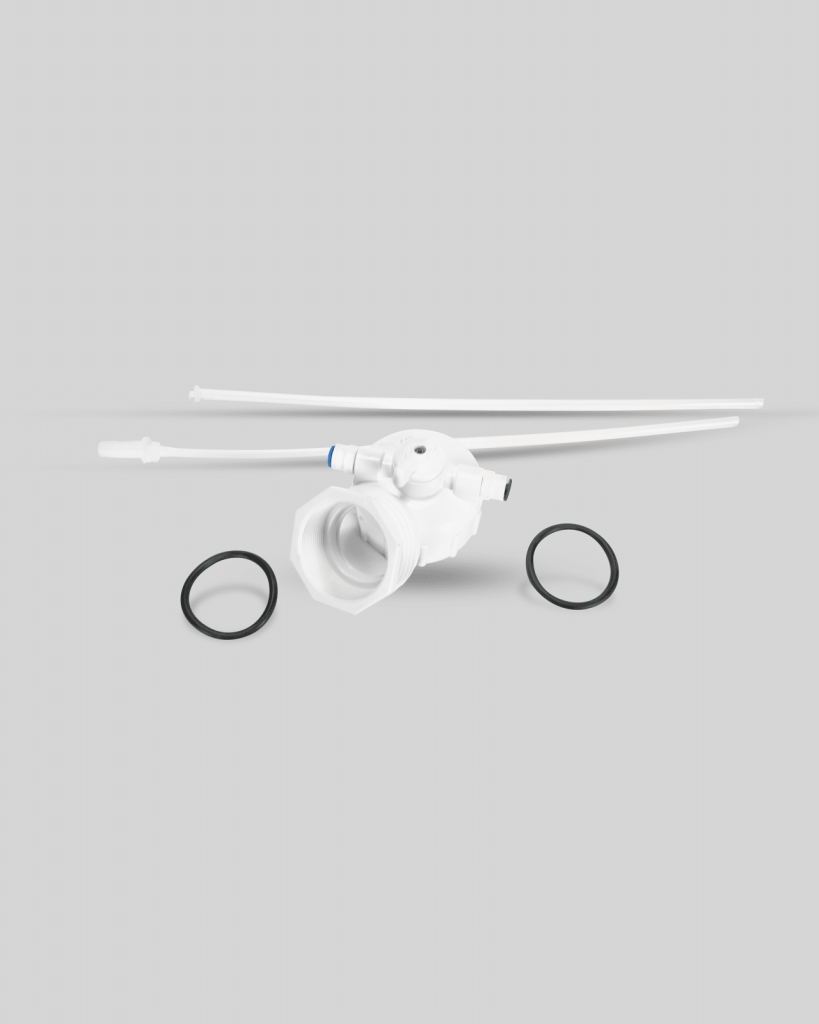 White plastic valve assembly 1134 with two long tubes and two black rubber O-rings, arranged on a plain gray background.