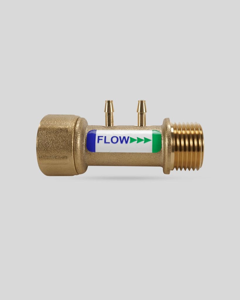 Brass flow sensor 1124 with threaded ends, two small side ports, and a label indicating "FLOW" with green arrows pointing right.