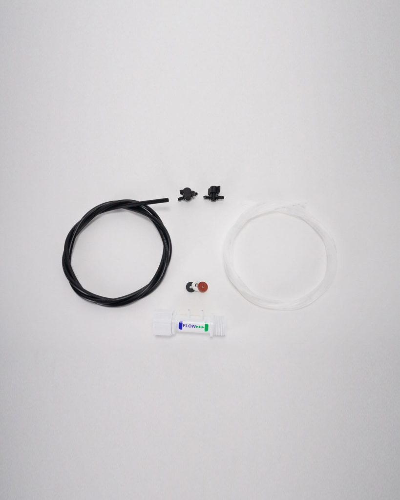 Assorted parts displayed on a white background, including black and white tubing, connectors, Import placeholder 2949, a small component with a red top, and a cylindrical container labeled "FLOW+".