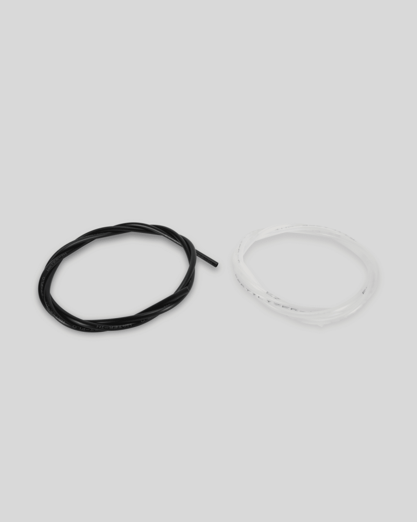 Two coiled cables, one black and one white, are placed side by side on a plain light gray background—ideal for Import placeholder,2952 projects or custom setups.